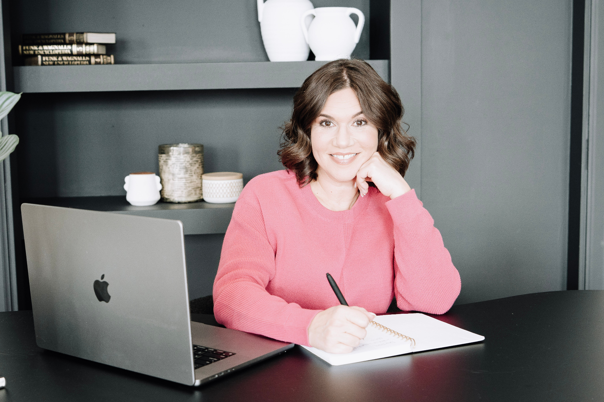 Lori writing at her desk